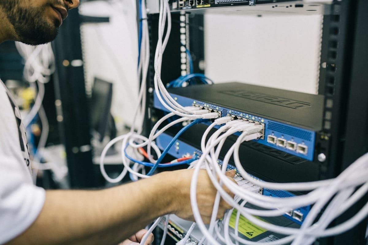 Fluke DSX-8000 copper and fiber cable certification testing at a patch panel on a Utah commercial project